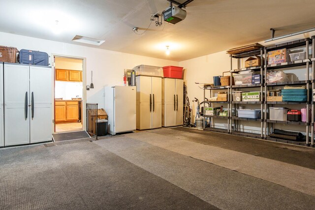 1103 Shingle Oak Ln Unit 3A, Rockford, IL 61107 - garage with a garage door opener, refrigerator, and freestanding refrigerator