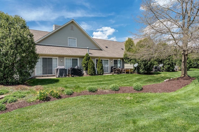 1103 Shingle Oak Ln Unit 3A, Rockford, IL 61107 - rear view of property with a lawn, roof with shingles, and a chimney