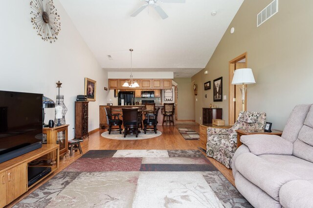 1103 Shingle Oak Ln Unit 3A, Rockford, IL 61107 - living area featuring light wood finished floors, ceiling fan, high vaulted ceiling, visible vents, and baseboards