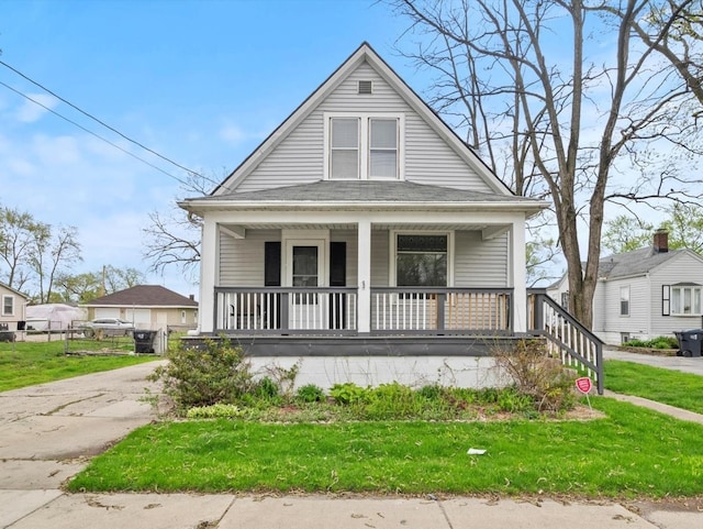view of front of property with a porch and a front yard