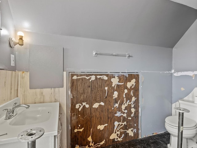 bathroom with a sink, marble finish floor, and toilet