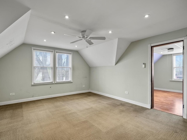 additional living space with carpet floors, baseboards, ceiling fan, and vaulted ceiling