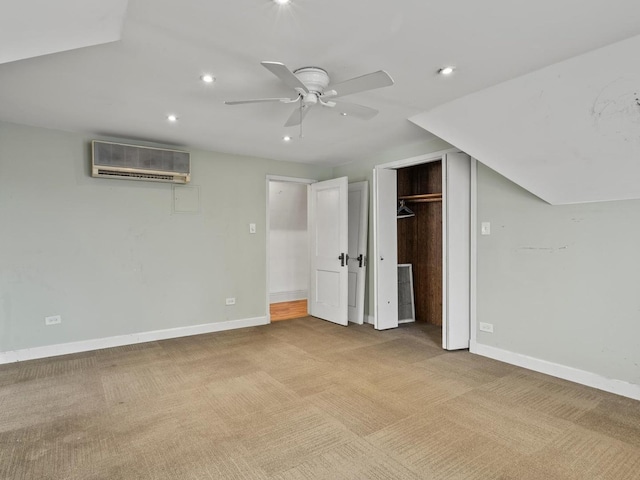 unfurnished bedroom featuring baseboards, a wall mounted AC, carpet flooring, and recessed lighting