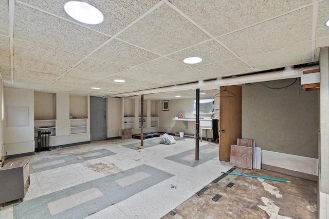 finished below grade area with a paneled ceiling