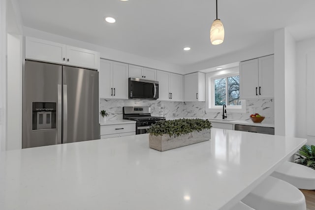 245 N Smith St Unit 2W, Palatine, IL 60067 - kitchen with white cabinetry, a sink, stainless steel appliances, light countertops, and backsplash