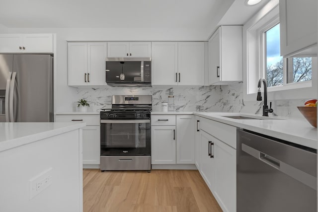 245 N Smith St Unit 2W, Palatine, IL 60067 - kitchen featuring decorative backsplash, stainless steel appliances, light countertops, a sink, and light wood-type flooring