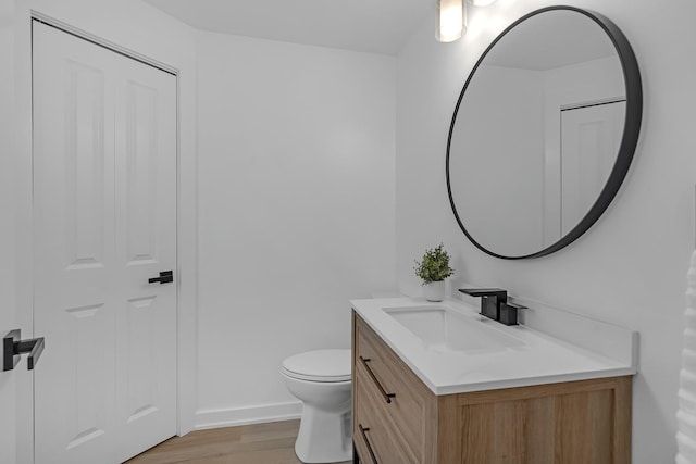 245 N Smith St Unit 2W, Palatine, IL 60067 - bathroom featuring toilet, wood finished floors, vanity, and baseboards