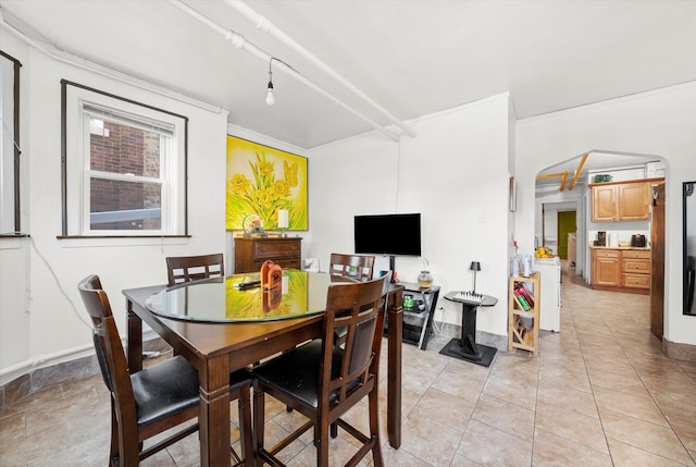 3924 W 64th Pl, Chicago, IL 60629 - dining room with arched walkways, light tile patterned floors, and baseboards