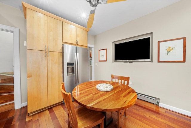 3924 W 64th Pl, Chicago, IL 60629 - dining space featuring baseboard heating, light wood-type flooring, and baseboards