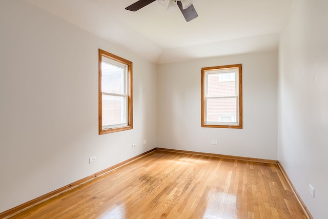empty room with ceiling fan, baseboards, and light wood-type flooring