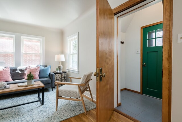 entryway with baseboards and wood finished floors