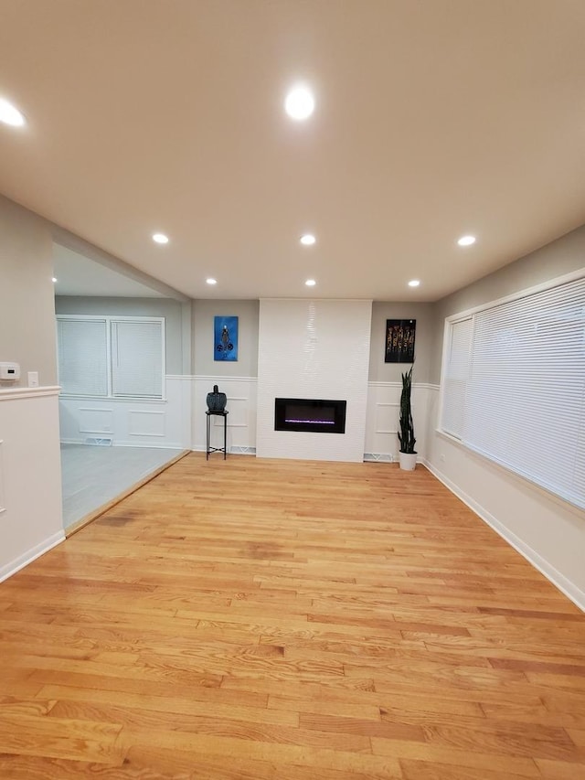 530 E 91st Pl, Chicago, IL 60619 - below grade area with recessed lighting, light wood-style flooring, a decorative wall, wainscoting, and a fireplace