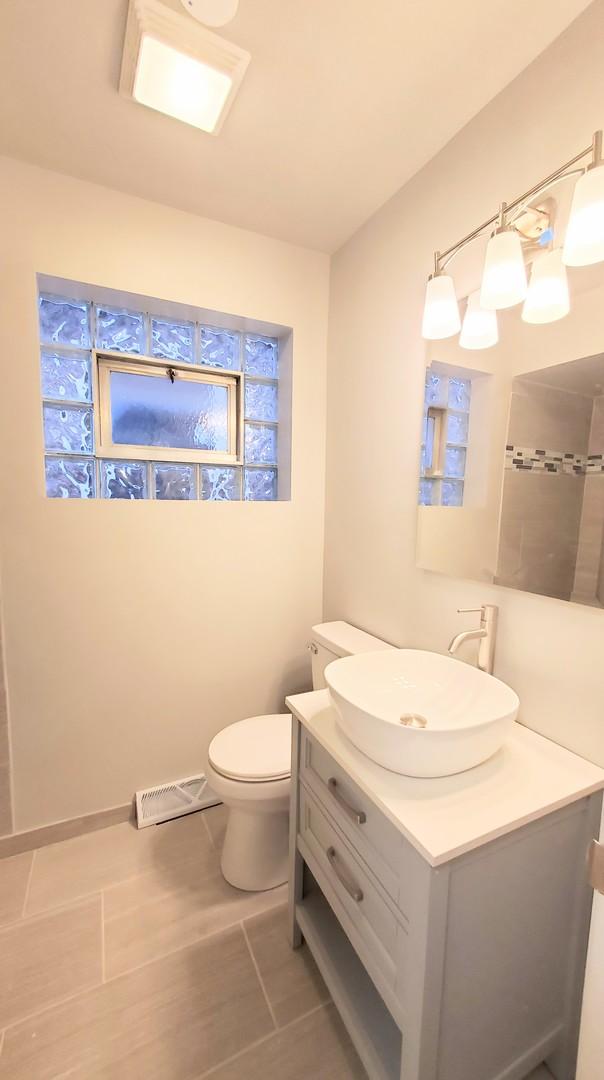 530 E 91st Pl, Chicago, IL 60619 - bathroom with toilet, visible vents, and vanity