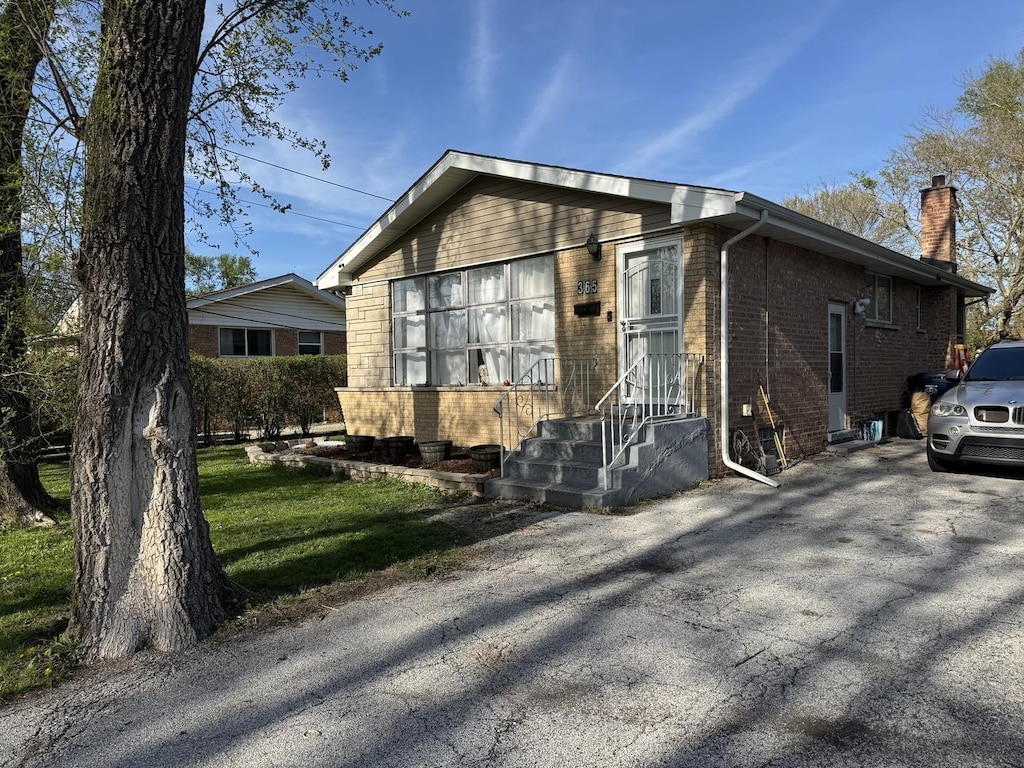 365 Sherry Ln, Chicago Heights, IL 60411 - view of front of home featuring brick siding and a chimney