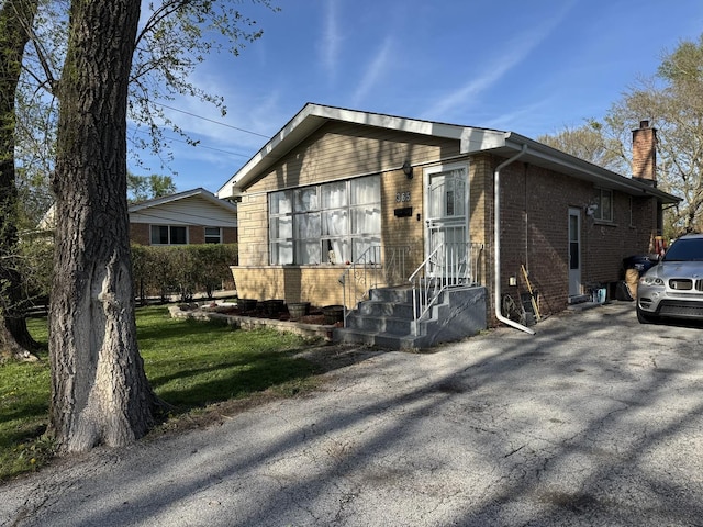 365 Sherry Ln, Chicago Heights, IL 60411 - view of front of home featuring brick siding and a chimney