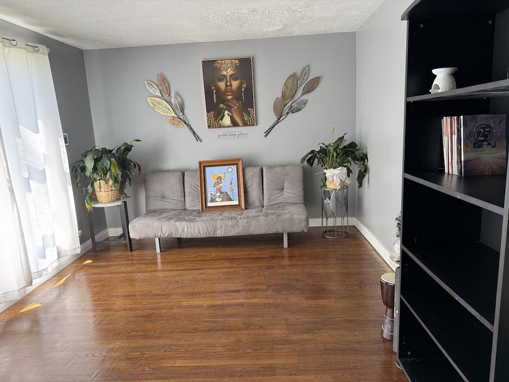 365 Sherry Ln, Chicago Heights, IL 60411 - sitting room with baseboards, a textured ceiling, and wood finished floors