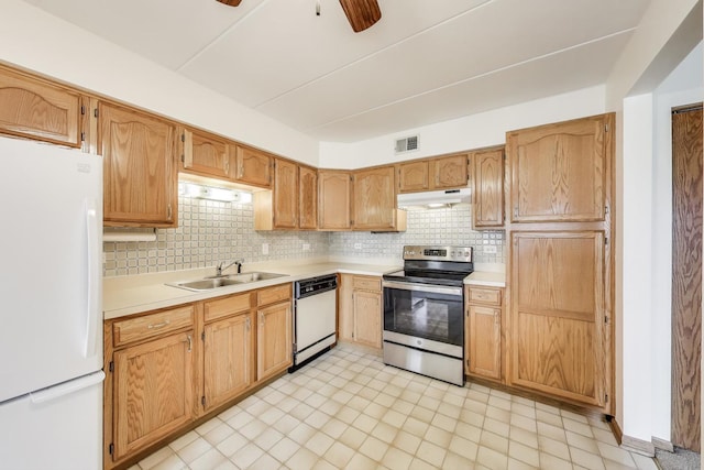 kitchen featuring visible vents, white appliances, light countertops, tasteful backsplash, and a sink