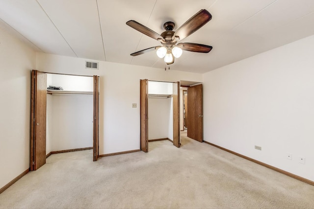 unfurnished bedroom featuring visible vents, baseboards, ceiling fan, and light colored carpet