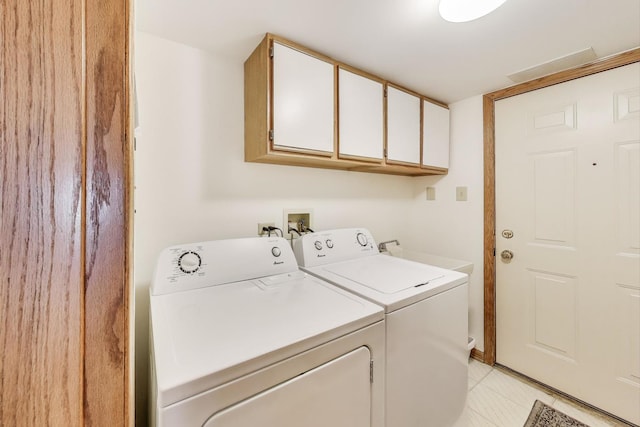 laundry room featuring cabinet space and washing machine and dryer