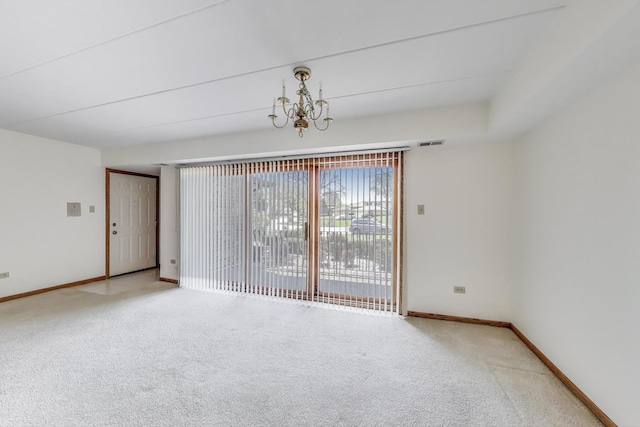 empty room with an inviting chandelier, baseboards, carpet, and visible vents