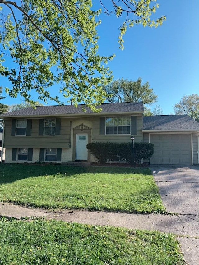 2007 E Vermont Ave, Urbana, IL 61802 - split foyer home with a front lawn, driveway, a garage, and brick siding