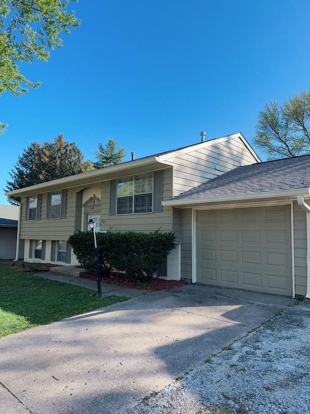 2007 E Vermont Ave, Urbana, IL 61802 - split foyer home featuring concrete driveway and an attached garage