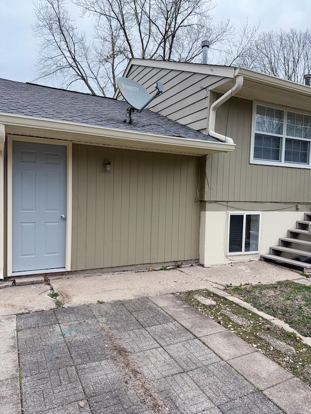2007 E Vermont Ave, Urbana, IL 61802 - view of exterior entry with a patio and roof with shingles