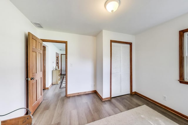 2021 Oak Dr, Mchenry, IL 60050 - unfurnished bedroom featuring wood finished floors and a closet