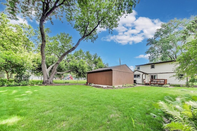 2021 Oak Dr, Mchenry, IL 60050 - view of green lawn with a deck and a storage unit