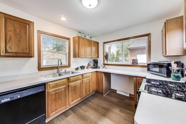 2021 Oak Dr, Mchenry, IL 60050 - kitchen with black appliances, dark wood-style flooring, plenty of natural light, light countertops, and recessed lighting