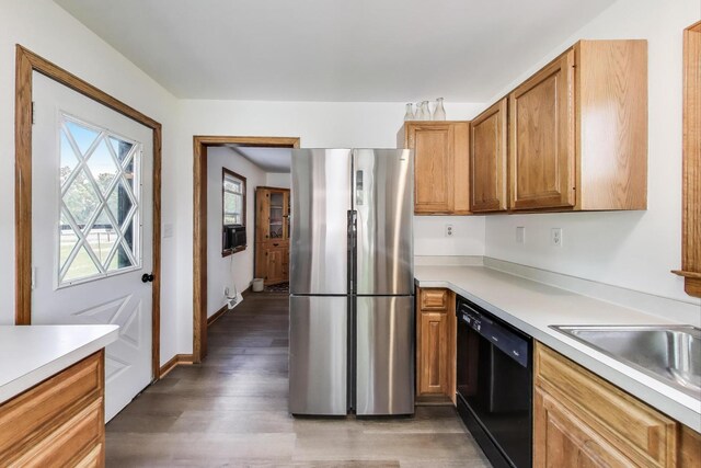 2021 Oak Dr, Mchenry, IL 60050 - kitchen featuring freestanding refrigerator, dishwasher, light countertops, wood finished floors, and brown cabinetry