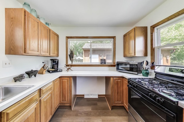 2021 Oak Dr, Mchenry, IL 60050 - kitchen with appliances with stainless steel finishes, wood finished floors, light countertops, and built in desk