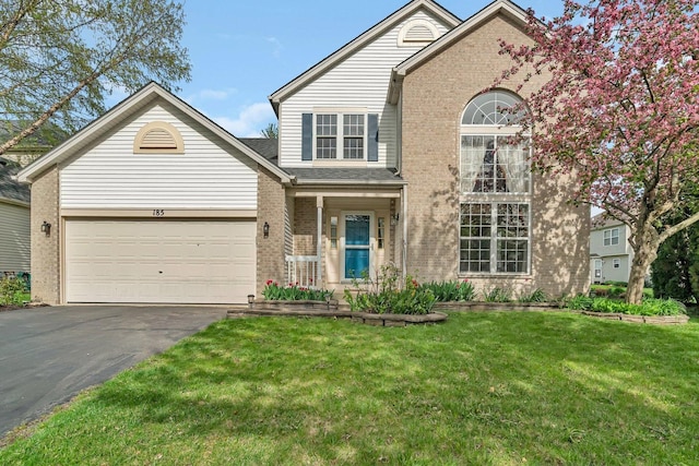 185 Wedgeport Cir, Romeoville, IL 60446 - traditional home with a front lawn, brick siding, driveway, and a garage