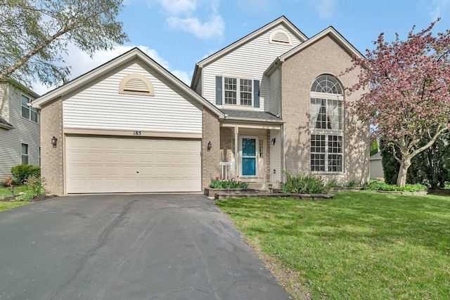 185 Wedgeport Cir, Romeoville, IL 60446 - traditional-style house with an attached garage, brick siding, a front yard, and aphalt driveway