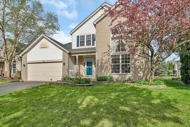 185 Wedgeport Cir, Romeoville, IL 60446 - traditional-style house with an attached garage, a front yard, brick siding, and driveway