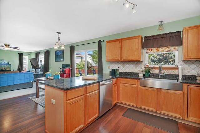 185 Wedgeport Cir, Romeoville, IL 60446 - kitchen with a peninsula, a sink, dark wood-type flooring, dishwasher, and decorative backsplash