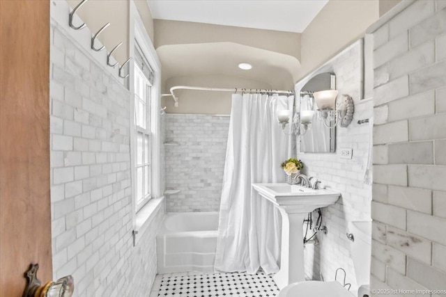 bathroom with tile patterned flooring and shower / tub combo