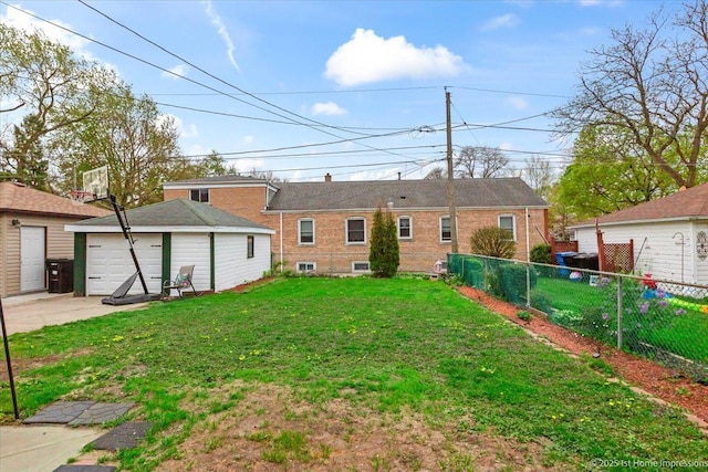 exterior space featuring a lawn, a detached garage, fence, an outdoor structure, and concrete driveway