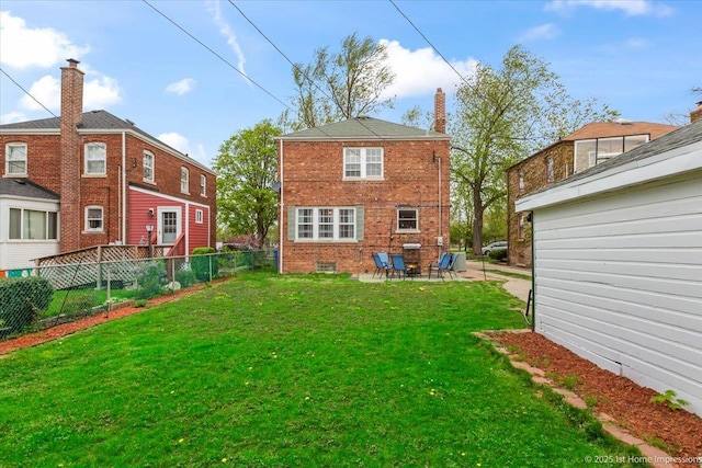 back of house with fence, a patio, a yard, and brick siding