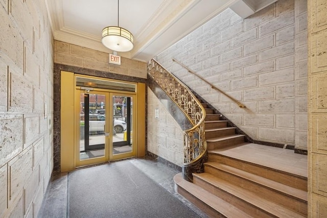 entrance foyer with crown molding, french doors, and stairway