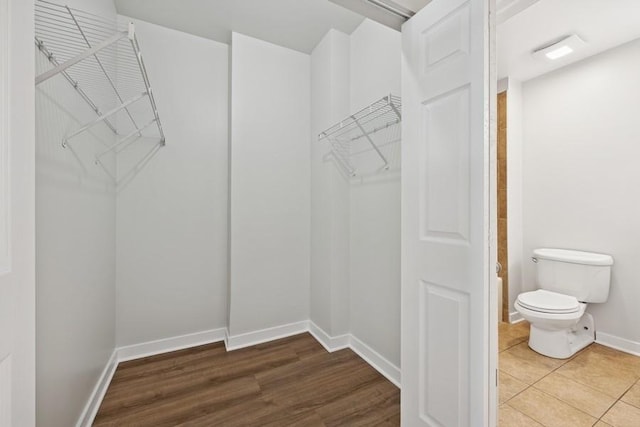 spacious closet with wood finished floors