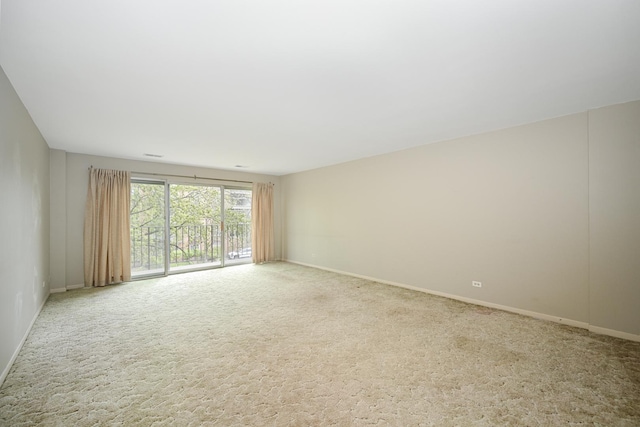 unfurnished room with carpet flooring and baseboards