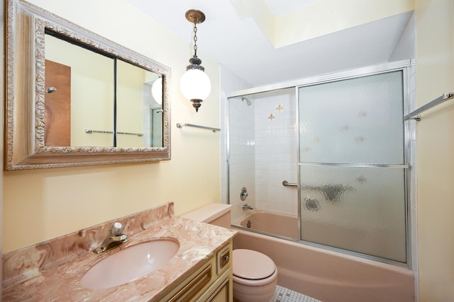 full bathroom with toilet, a skylight, enclosed tub / shower combo, and vanity