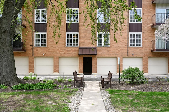 view of front facade with brick siding and an attached garage