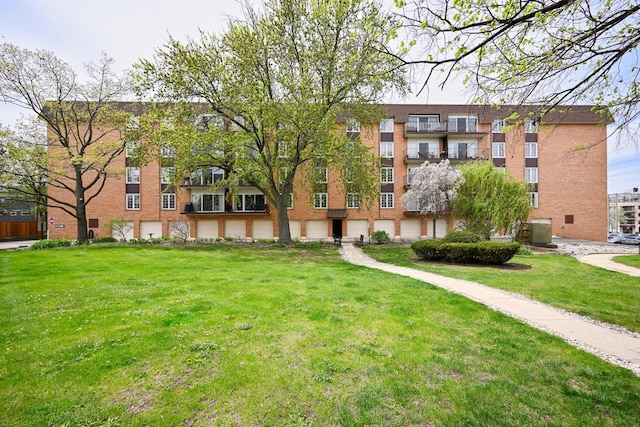 view of home's community featuring a lawn