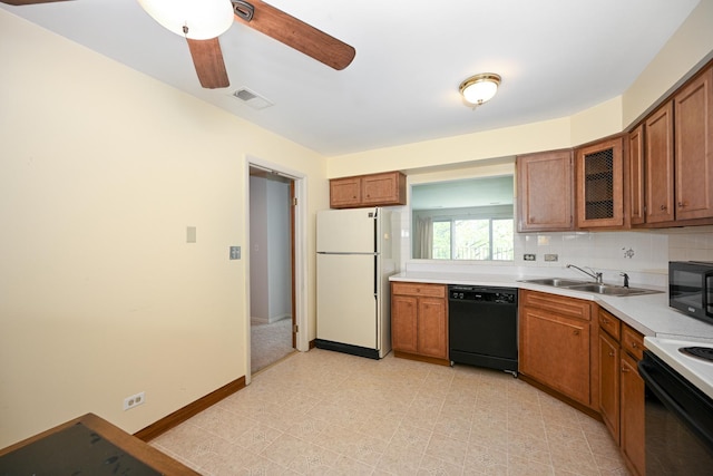 kitchen with a sink, black appliances, brown cabinets, and visible vents