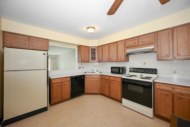 kitchen with under cabinet range hood, a ceiling fan, a sink, and black appliances