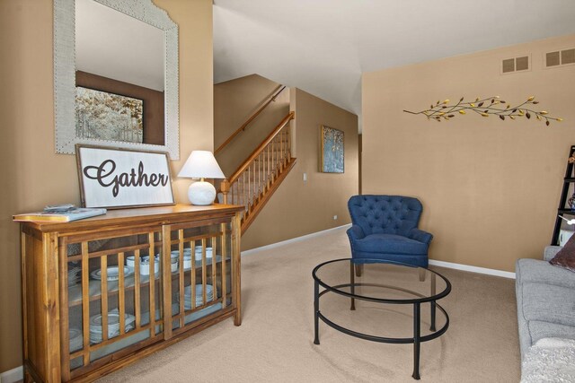 sitting room featuring visible vents, carpet, and baseboards
