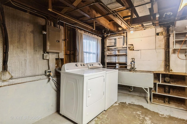 laundry area featuring a sink, laundry area, independent washer and dryer, and electric panel