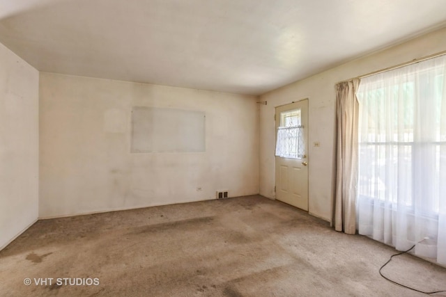 carpeted empty room with visible vents